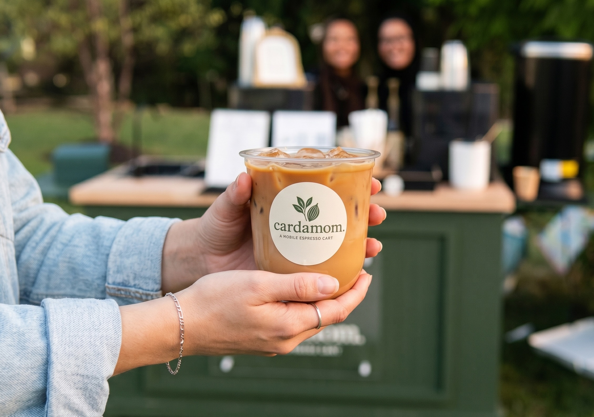Cardamom iced latte being held at a pop-up event